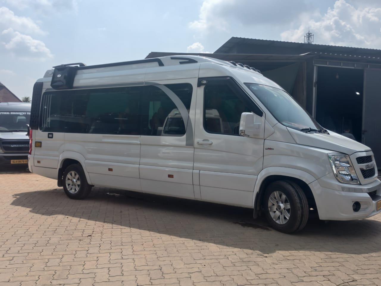 17-seater white Force Urbania group tourer parked in Kochi